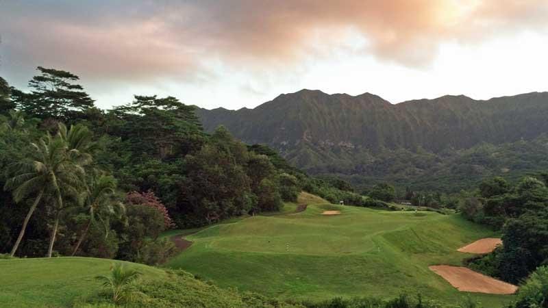 Royal Hawaiian Golf Club golfing experience in Oahu’s Koʻolau Mountains with emerald fairways, waterfalls, and jungle views